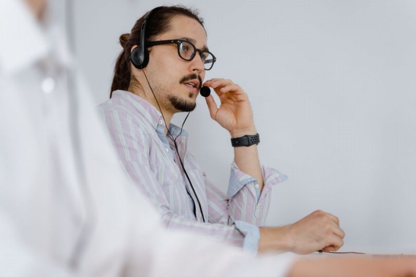 Tela de smartphone mostrando conversa automática e agente humano colaborando em atendimento